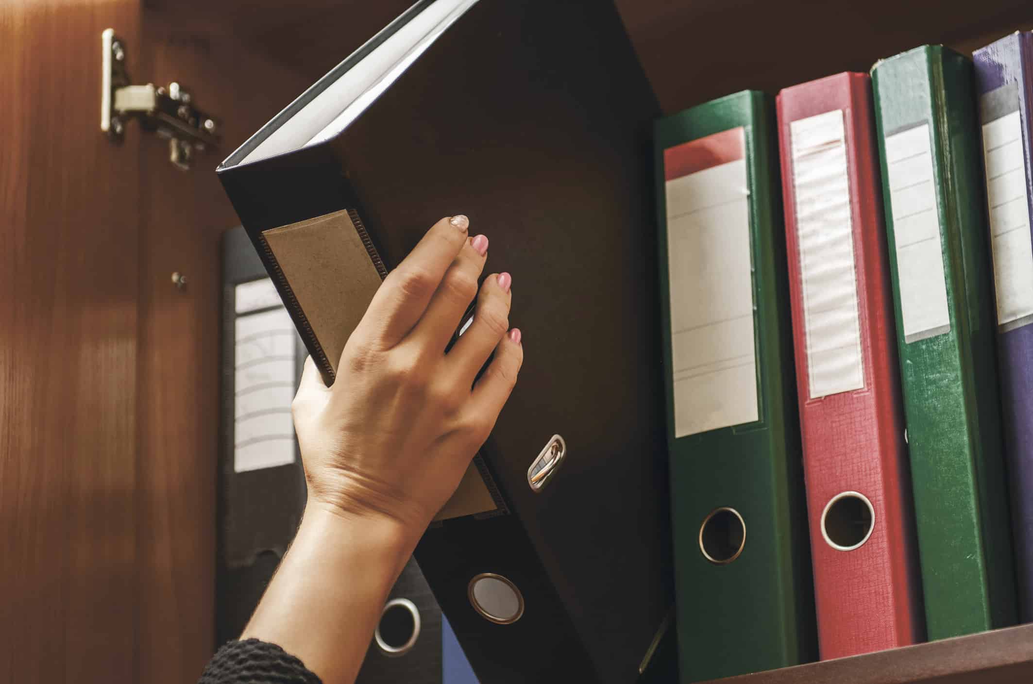 a woman officer pick a binder of document